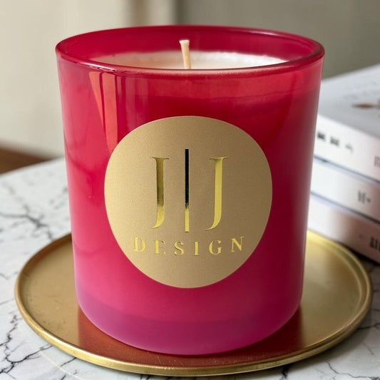 Pink luxury soy candle with a gold logo on a gold tray