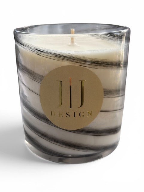 Marbled grey and black glass candle jar with white wax and gold circular label.
